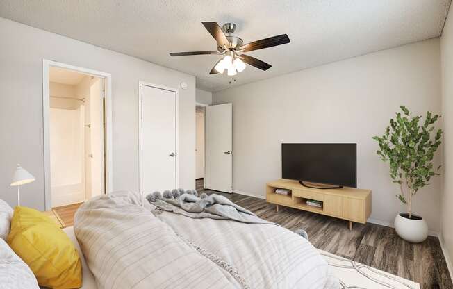 a bedroom with a large bed and a ceiling fan