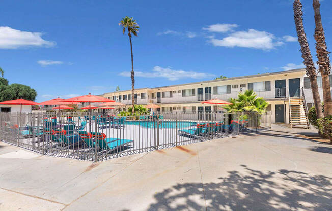 our apartments have a pool and patio with chairs and umbrellas at Sunnymead Apts Apartments, Moreno Valley, CA
