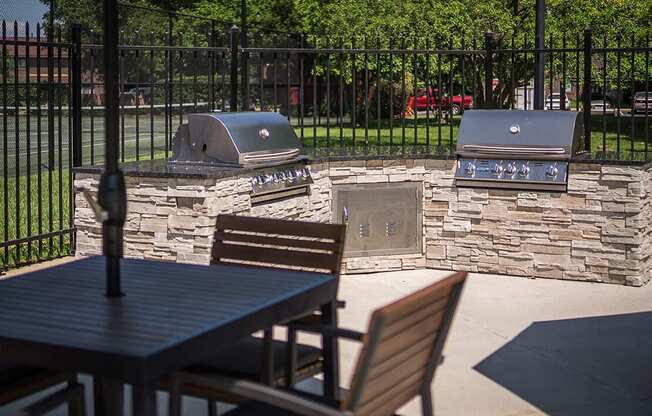 Outdoor Grill With Intimate Seating Area at Woodbridge Apartments, Louisville, Kentucky