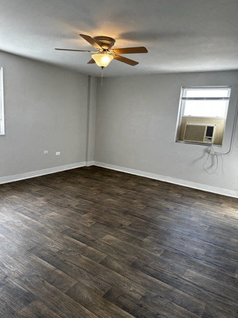 an empty room with a ceiling fan and a window