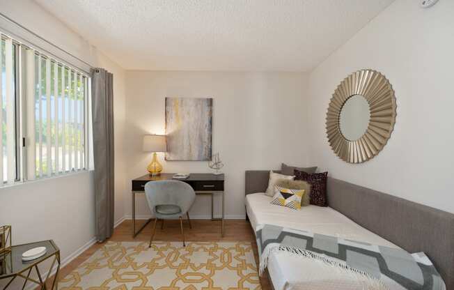a bedroom with a bed and a desk with a chair