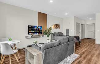 a living room with a couch and a table and a tv