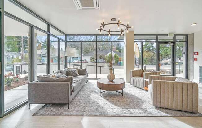 a living room with couches and chairs and a coffee table with a vase on it