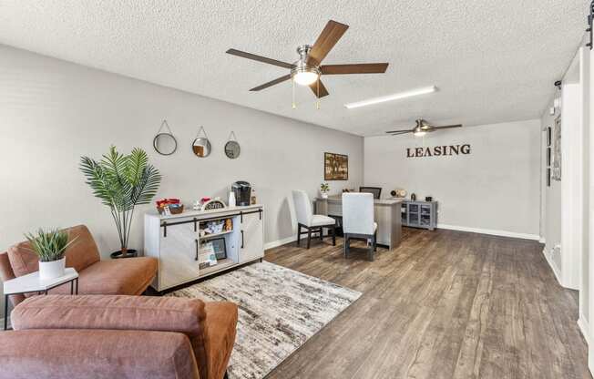 the living room and dining area of a house with a ceiling fan