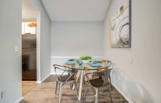 a dining room with a table and chairs