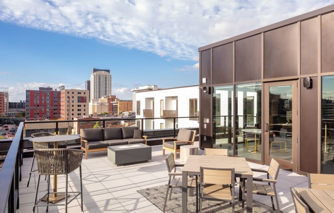a balcony with tables and chairs and a view of the city at Maven on Broadway, Rochester, MN, 55904