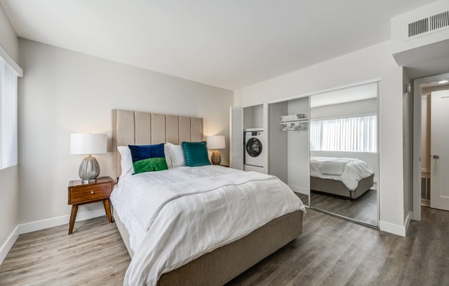Two-Bedroom Apartments in Encino, CA- Brookside Terrace Apartments- Bedroom with White Bedding, Mirror Closet Sliding Doors, and Double Nightstands