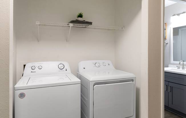 a washer and dryer in a laundry room with a sink