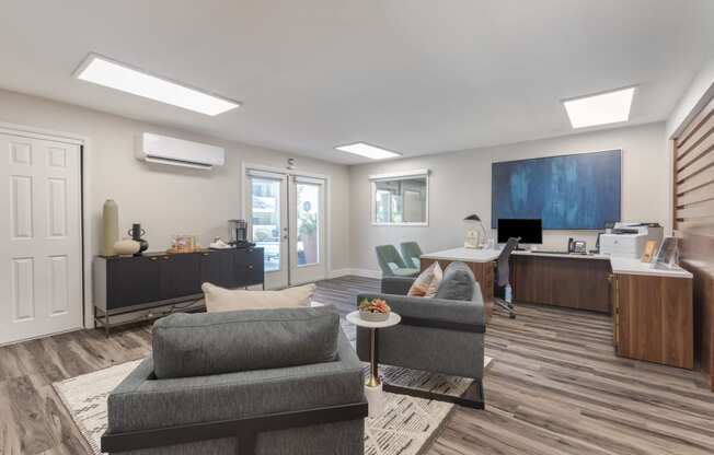 a living room with a couch and a coffee table and a desk