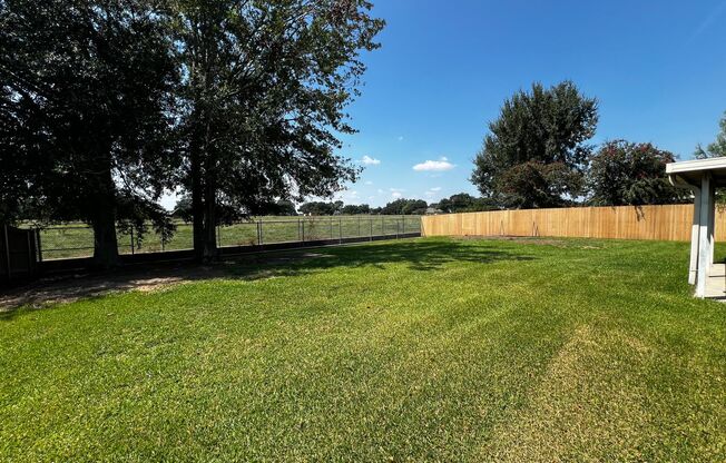 4 Bedroom, 2 Bathroom, large yard, 2 car carport, NEW floors and paint.