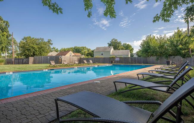 a group of lawn chairs sitting on a bench in a pool of water