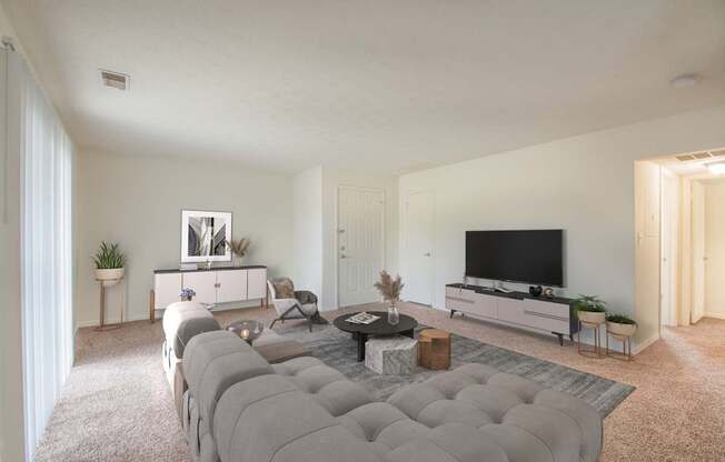 A modern living room with a grey sofa and a flat screen TV.