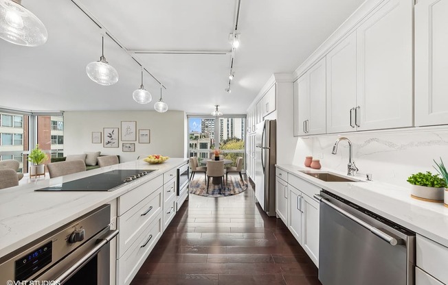 a large kitchen with white cabinets and stainless steel appliances