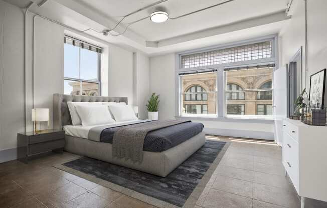 Downtown Los Angeles, CA Apartments for Rent - Santa Fe Lofts - Bedroom with Original Concrete Flooring and Hexagonal Plaster Detail, High Ceilings, Skylight, Oversized Windows, and Gorgeous Views of the City