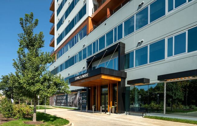 a building with a sidewalk and trees in front of it at Sinclaire on Seminary, Alexandria Virginia