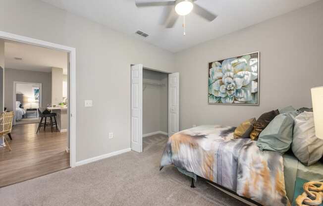 an open bedroom with a bed and a ceiling fan