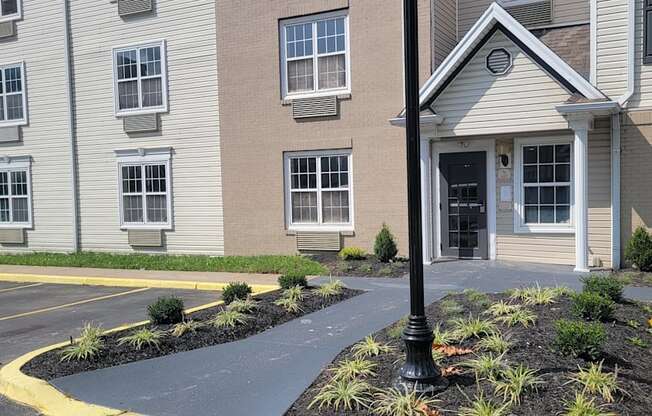 an apartment building with a black sidewalk in front of it