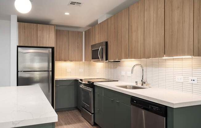 A modern kitchen with wooden cabinets and stainless steel appliances.