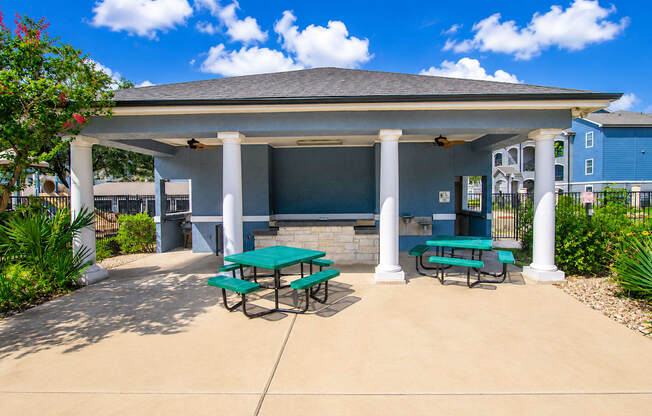 A covered picnic area with tables and benches.