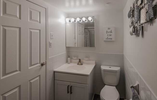 a small bathroom with a toilet and a sink at Glen Hollow, Croydon