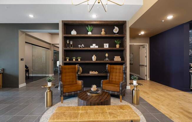 A modern living room with a fireplace and two chairs.