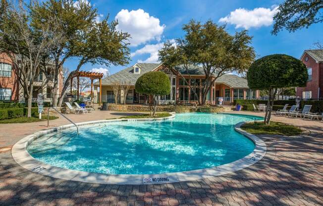 Plano TX Apartments for Rent - Carrington Park - Sparkling Pool Surrounded By Trees and Lounge Chairs