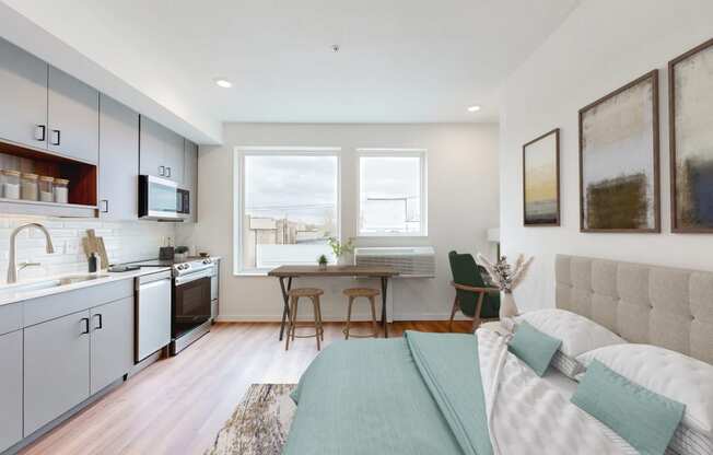 a living room and kitchen with a couch and a table