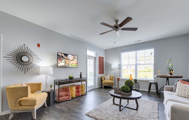 A living room with a yellow chair and a coffee table.