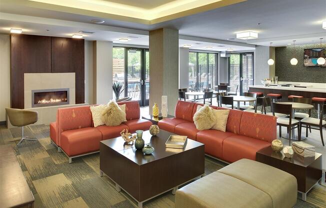 Be @ Axon Green Community Room with comfy chairs, couches, coffee table, and fire pit