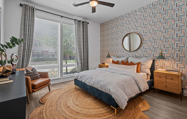 a bedroom with a bed and a ceiling fan