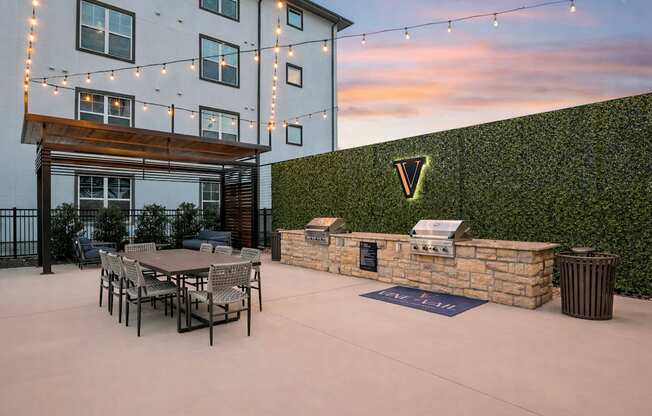 A patio area with a table and chairs is set up outside a building.