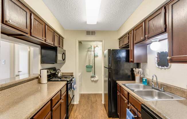 the preserve at ballantyne commons apartment kitchen with stainless steel appliances and wood cabinets