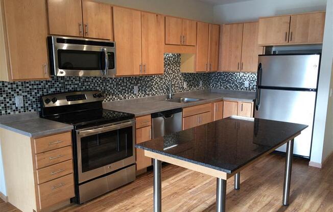 A kitchen with a stove, oven, and refrigerator.