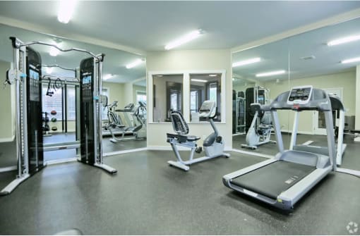 a gym with cardio equipment and weights at the monarch apartments in midtown