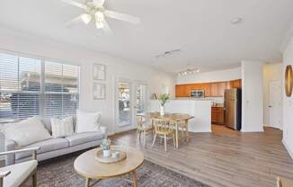 A living room with a grey couch and a wooden table.