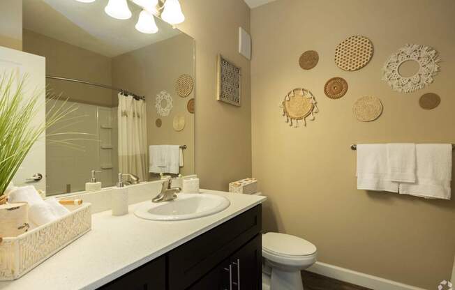 A bathroom with a white sink and a toilet.