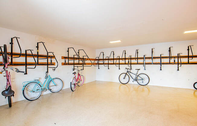 a room with several bikes hanging on a wall and a bike rack on the wall