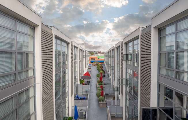A long corridor with a red awning at the end.