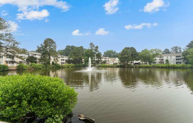 a fountain in the middle of a lake with apartment buildings in the background at Linkhorn Bay Apartments, Virginia Beach, VA, 23451