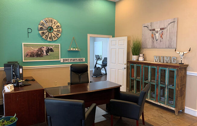 an office with a desk chairs and a clock on the wall
