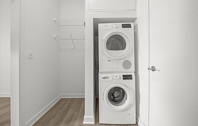 A white washing machine and dryer in a small laundry room.