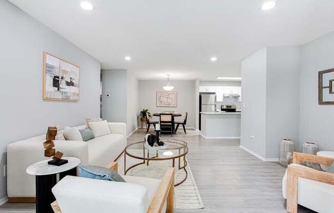 A living room with a white couch and a coffee table.