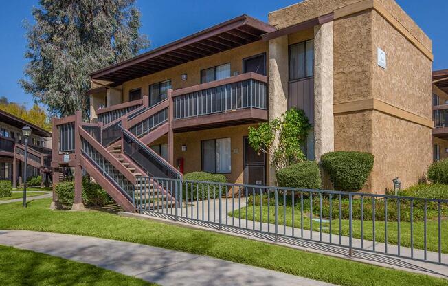 a house with a fence in front of a brick building