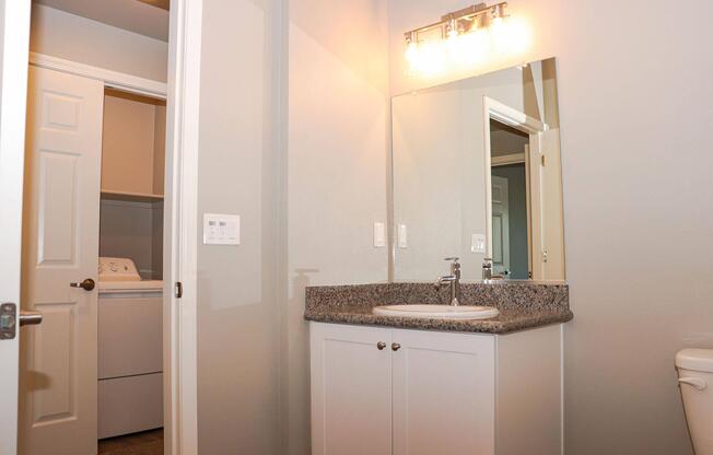 a room with a sink and a mirror
