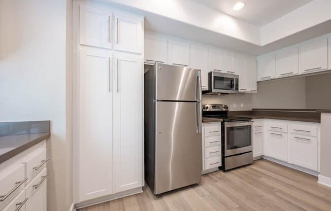 A kitchen with a stainless steel refrigerator, microwave, and oven. at Harbor Pointe, Dana Point