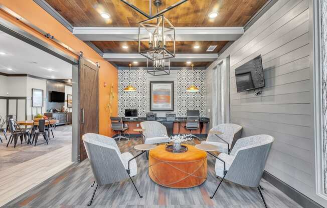 Modern living room with a wooden ceiling and grey chairs at Sterling Creek at Richmond Hill, Richmond Hill, GA, Georgia 