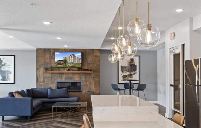 a living room with couches and a table and a kitchen