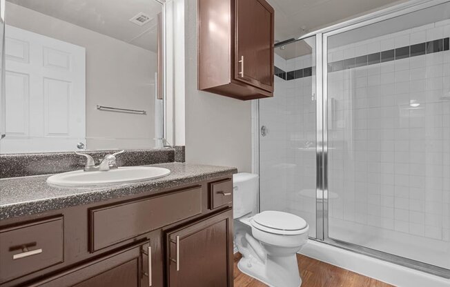 a bathroom with a toilet sink and shower