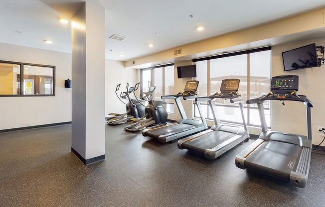 Fitness center with hard rubber flooring, 3 treadmills and 2 ellipticals