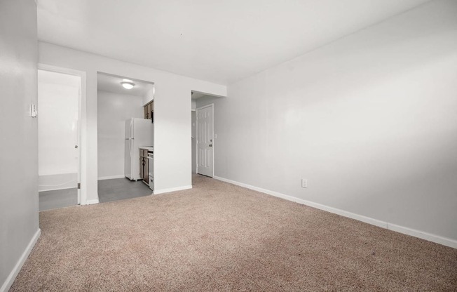 A room with a carpeted floor and white walls.